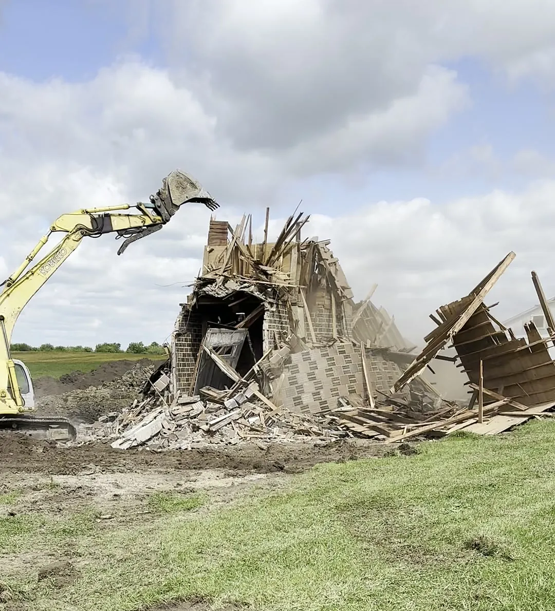 The farmhouse down to a pile of lumber and brick, ready to haul